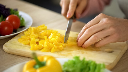 Retired female hands cutting fresh vegetables, grandmother cooking healthy lunch