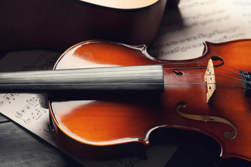 Violin and music sheets on table, closeup