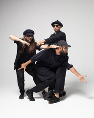 Hip hop dancers moving and jumping in photostudio