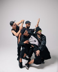 Hip hop dancers moving and jumping in photostudio