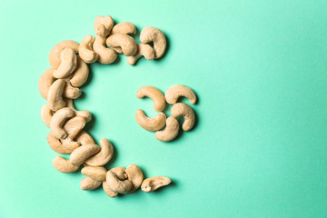 Half-moon and star made of cashew as symbol of Islam on color background