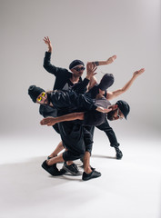 Hip hop dancers moving and jumping in photostudio