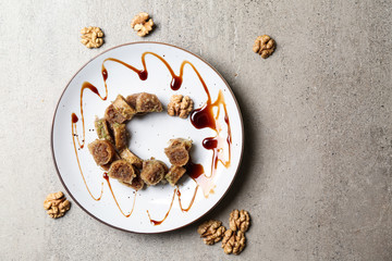 Plate with Arabian dessert in shape of half-moon as symbol of Islam on light background