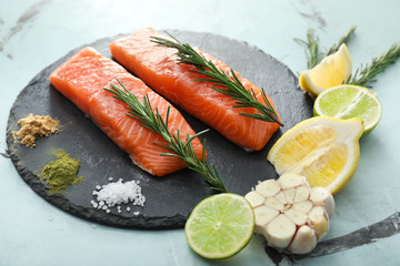 Composition with raw salmon fillet on slate plate