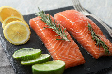 Raw salmon fillet on slate plate, closeup