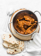 Pork ribs curry in pan on light background, top view