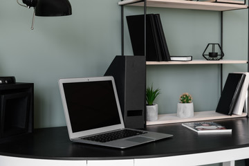 Comfortable workplace with modern laptop