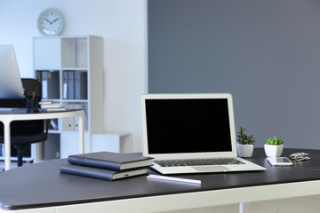 Comfortable workplace with modern laptop in office