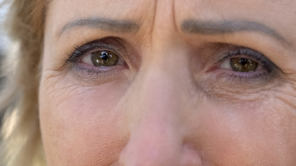 Old lady eyes full of tears begging for help, pain of loss, tears of despair