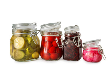 Jars with tasty fermented vegetables on white background