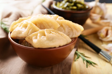 Bowl with tasty Japanese gyoza on wooden table