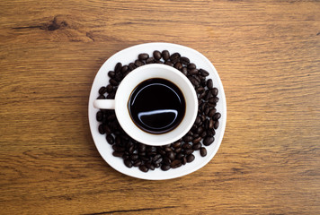Coffee cup and coffee beans on table