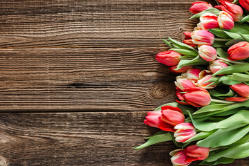 Fresh tulips, top view. Colorful spring tulip bouquet on wooden background. Mothers day flowers or card for women day.