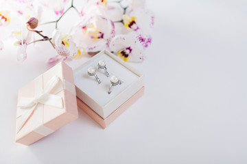 Set of silver ring and earrings with pearls in the gift box with orchid. Present for Valentine's day
