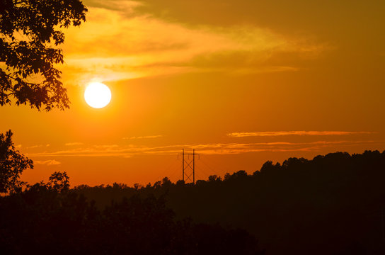 Power lines punctuate the landscape as the sun sets in Coldwater, Alabama, USA