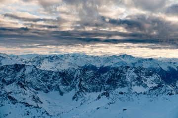 Scenic aerial view of snowy Zugspitze mountains on sunset in Bavarian Alps, Germany. Panoramic view