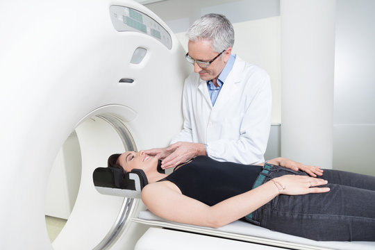 young lady with the doctor in the room of computed tomography at hospital.