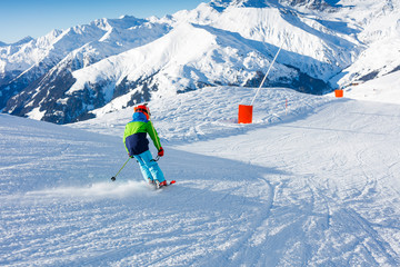 Cute skier boy in a winter ski resort.