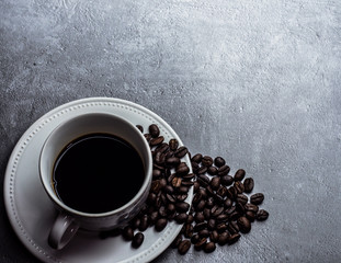 Coffee cup and coffee beans on table