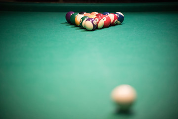 Entertainment concept. Billiard table with bright colored balls