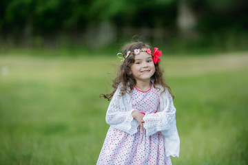 Mother and daughter in a meadow near a mountain lake