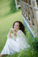 Naklejka premium Beautiful bride in gorgeous white wedding dress standing near the lake Morskie Oko in the mountains on sunny summer day
