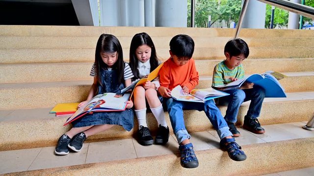 A Group of Asian Kids Reading Book Together