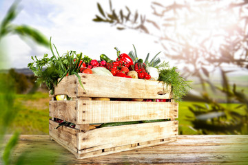 Vegetables in the basket box  chest on the wooden table background