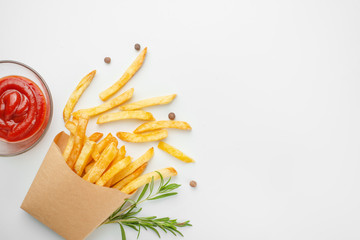 rosemary french fries and sauce in a paper cup on a white background