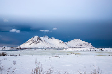 frozen lake and snow-covered mountains, Lofoten Islands, Norway