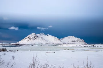 Fotobehang frozen lake and snow-covered mountains, Lofoten Islands, Norway © Giuma