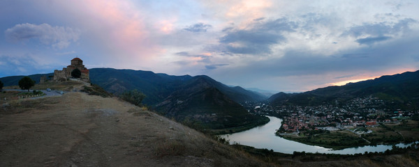 Evening panorama of the city of Mtskheta Georgia at sunset overlooking the historic center of the city, the temple of Jvari and the confluence of the Aragvi rivers and sunset kura in the summer