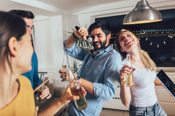 Group of friends playing karaoke at home. Concept about friendship, home entertainment and people