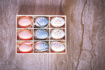 Easter eggs hand painted inside a gift box, photo for advertising use.