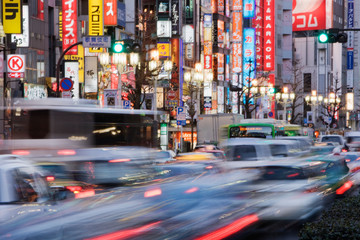 Street scene at night, banners and advertising, motion blur traffic