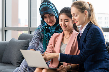 Multicultural working group. Team of businesswomen of different ethnicity, Caucasian, Asian and...