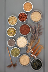 Dried health food selection with nuts, cereals, grains, seeds and wakame seaweed with herbs used in...