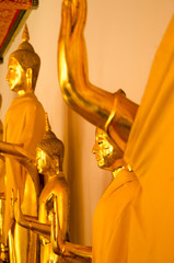 Obraz premium Traditional yellow gold statue of buddha meditating and praying in the royal palace temple for mind body soul spirit wellness and zen calmness