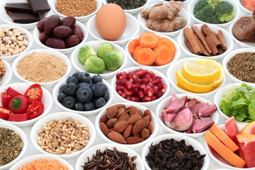 Super food to slow the ageing process concept including fruit, vegetables, seeds, nuts, herbs, spices, green and black teas. Very high in antioxidants, anthocyanins, dietary fibre and vitamins.
