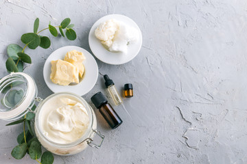diy body butter with ingrdients on concrete background