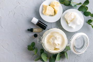 diy body butter with ingrdients on concrete background