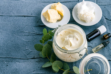 diy body butter with ingrdients on concrete background