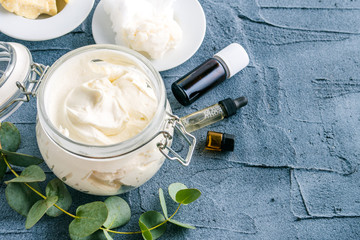 diy body butter with ingrdients on concrete background