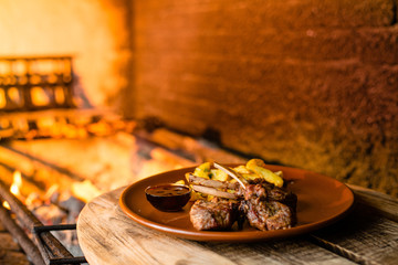 fried ribs with potatoes and gravy on a clay plate