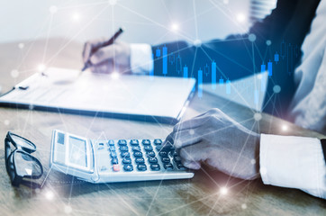 investor or business man using calculator for calculating and analysis financial report with...