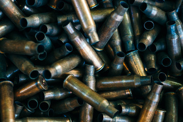 pile of used rifle cartridges 7.62 mm caliber, many empty bullet shells, assault rifle bullet...