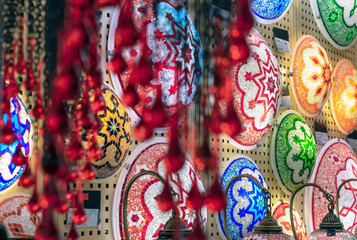 Oriental lamps from a multi-colored mosaic in the shop window.