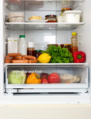 Open fridge full of vegetables and fruits and healthy products,