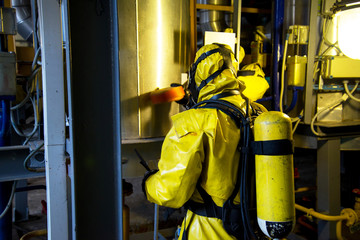 Rescuers in a radiation protection suit.