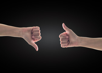 Like - unlike hand with thumb up - down symbolic people gesture isolated on black background with clipping path